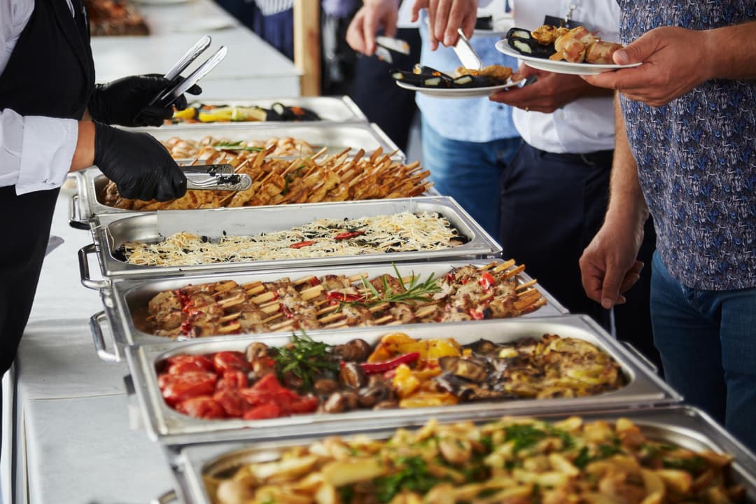 Guests serving themselves from a catered buffet line
